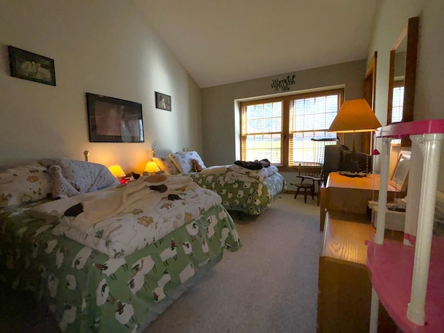 carpeted bedroom featuring vaulted ceiling