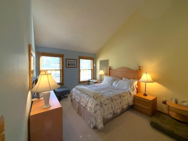 bedroom with high vaulted ceiling and carpet