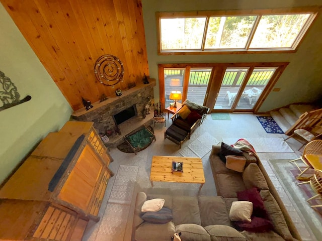 living room with a high ceiling and a fireplace