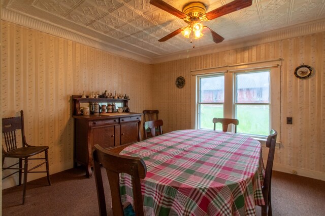 carpeted dining space with ornamental molding and ceiling fan