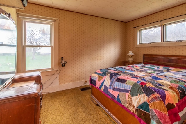 carpeted bedroom featuring crown molding