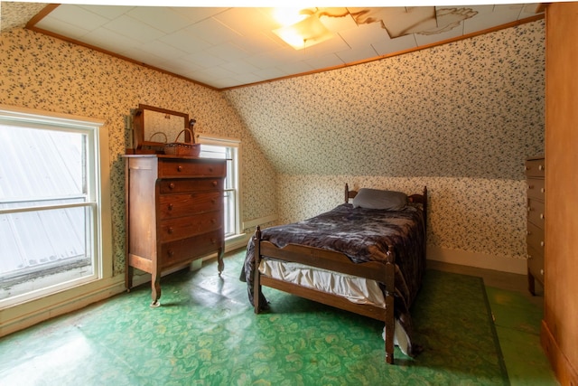 bedroom with vaulted ceiling and multiple windows