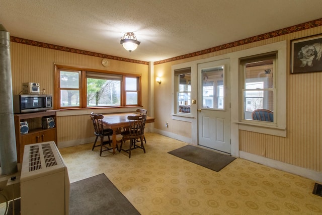 dining area featuring a textured ceiling