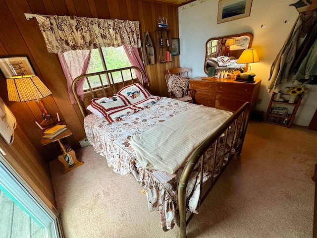 carpeted bedroom with wood walls