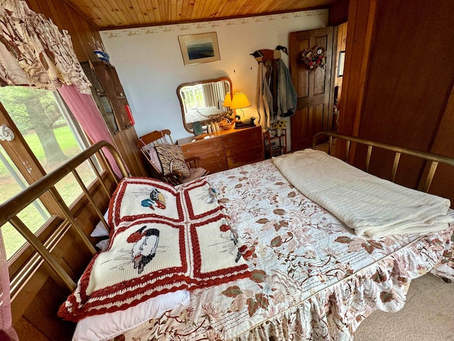 carpeted bedroom with wooden ceiling