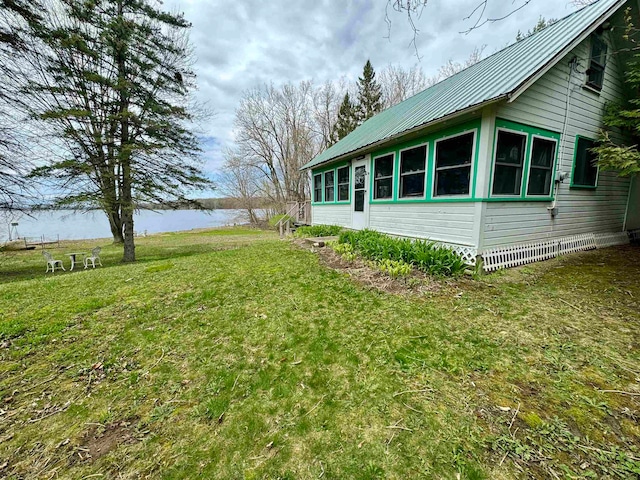 view of side of home featuring a yard