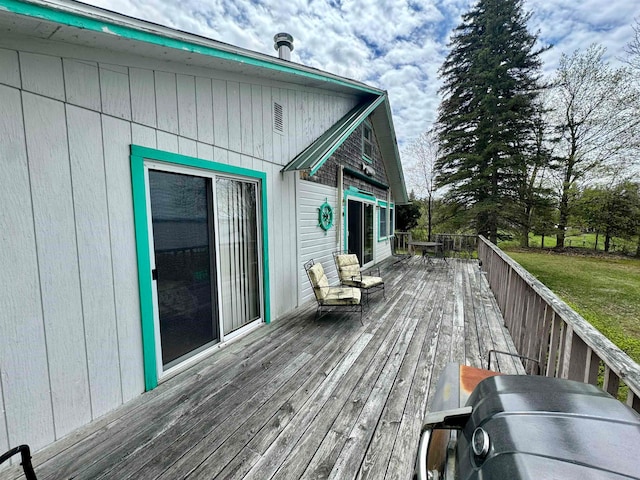 wooden deck with a lawn