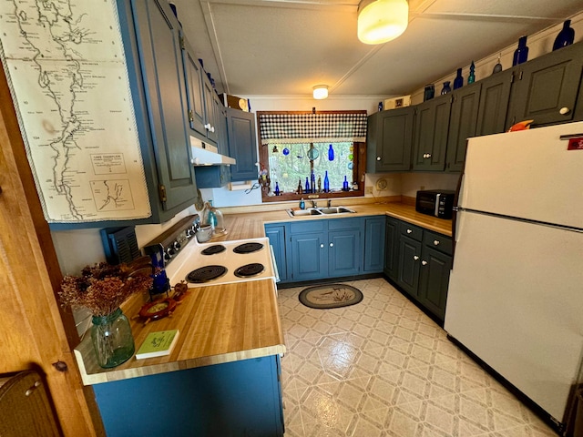 kitchen featuring butcher block countertops, light tile flooring, white refrigerator, stove, and crown molding