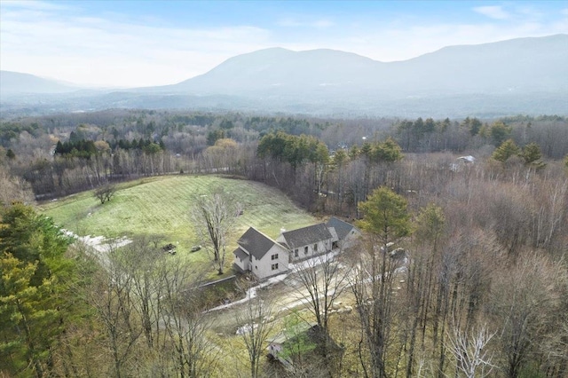 birds eye view of property featuring a forest view and a mountain view