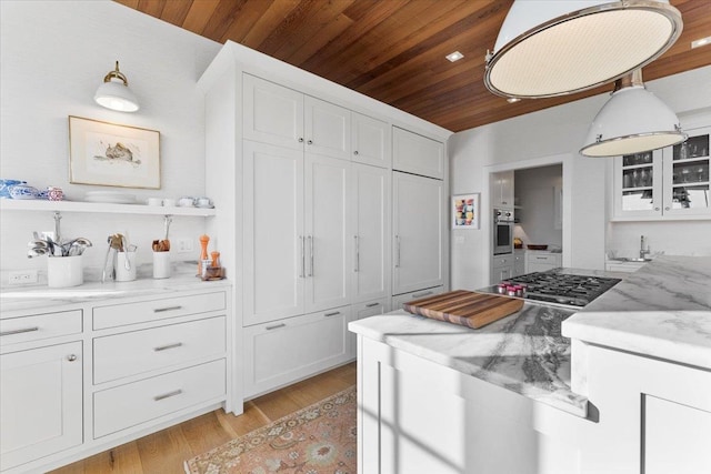 kitchen with white cabinetry, stainless steel appliances, and wood ceiling