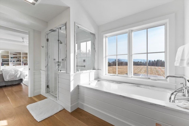 ensuite bathroom featuring ensuite bathroom, visible vents, a shower stall, a garden tub, and wood finished floors