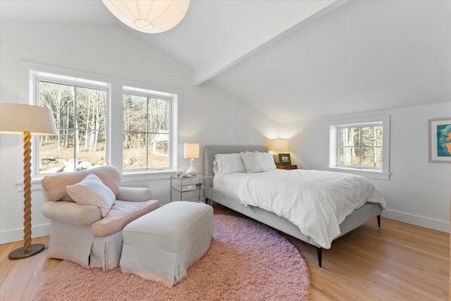 bedroom with baseboards, wood finished floors, and lofted ceiling with beams