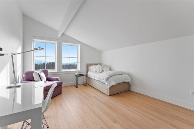 bedroom featuring baseboards, lofted ceiling with beams, and light wood-type flooring