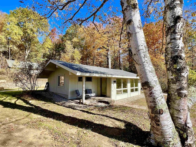 view of home's exterior featuring roof with shingles