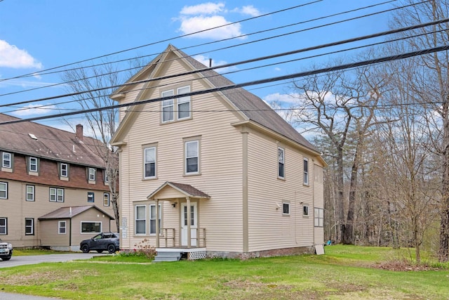 view of property featuring a front lawn