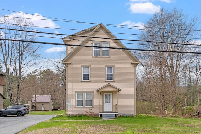 view of property featuring a front lawn