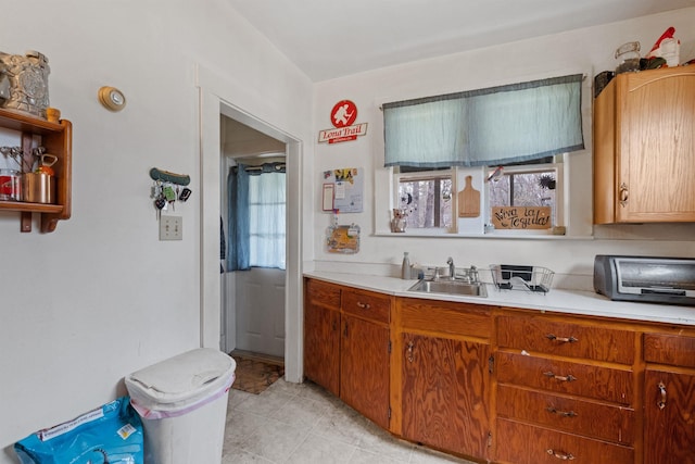 kitchen featuring sink and light tile floors