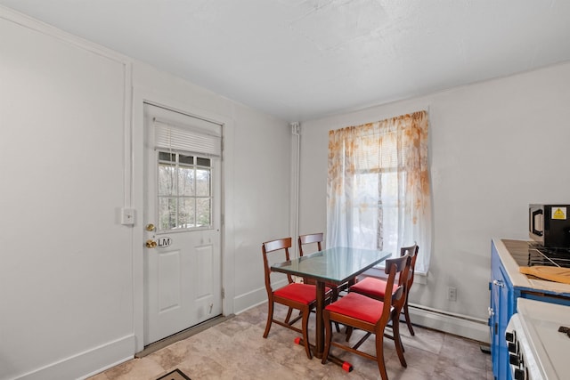 tiled dining area featuring baseboard heating