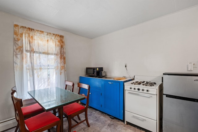 kitchen with a baseboard radiator, white gas stove, blue cabinetry, light tile floors, and stainless steel fridge