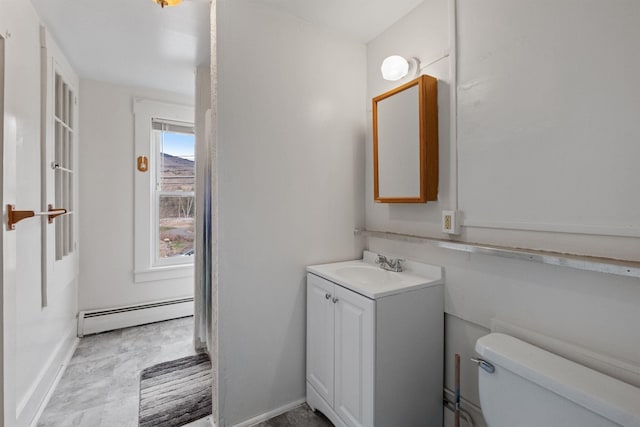 bathroom featuring a baseboard heating unit, toilet, tile flooring, and large vanity