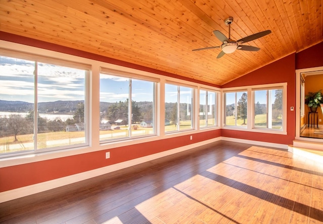 unfurnished sunroom featuring wood ceiling, a ceiling fan, and vaulted ceiling