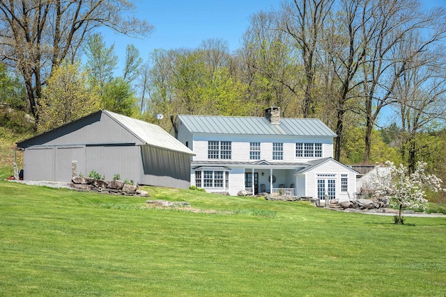 back of house featuring a lawn