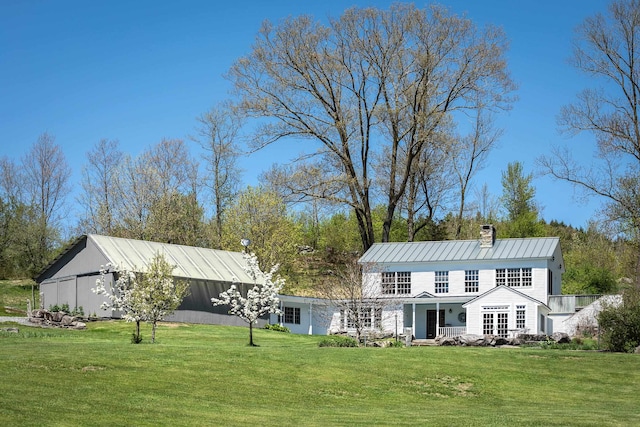 rear view of property featuring a lawn