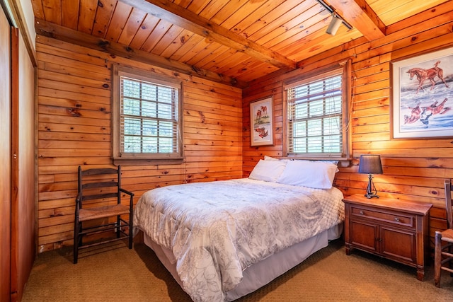 bedroom featuring light colored carpet, wooden ceiling, beam ceiling, and multiple windows