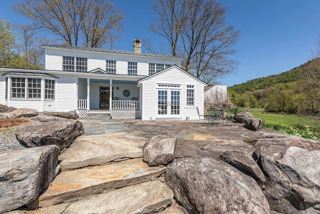 view of front facade with french doors and a patio area