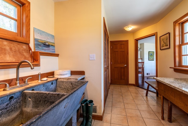 bathroom with plenty of natural light, tile flooring, and sink