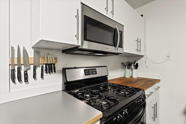 kitchen with white cabinetry and gas stove