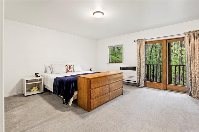 carpeted bedroom featuring heating unit and access to exterior