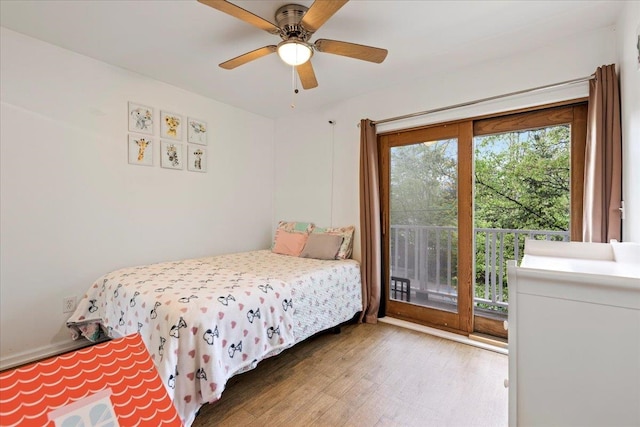 bedroom featuring hardwood / wood-style flooring, ceiling fan, and access to outside