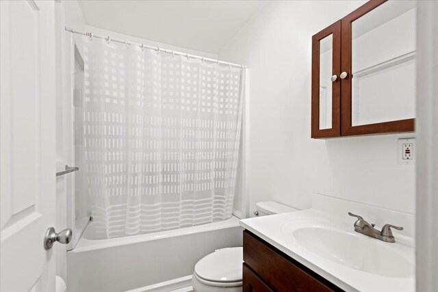 full bathroom featuring shower / bath combination with curtain, vanity, and toilet