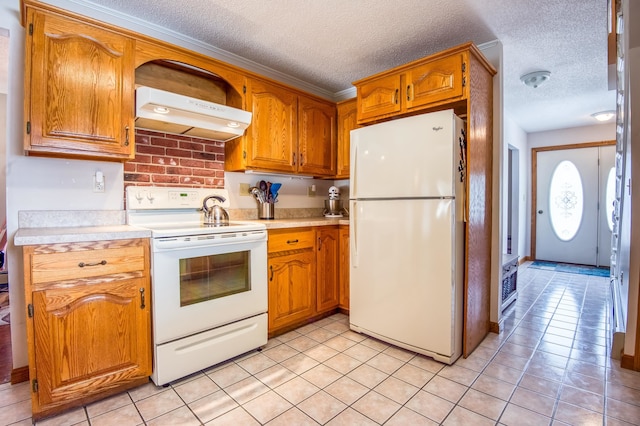 kitchen with white appliances, a textured ceiling, and light tile flooring