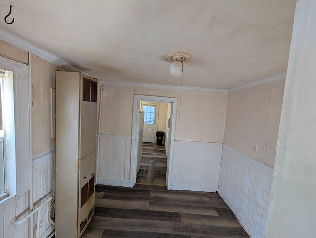 hallway featuring crown molding and dark hardwood / wood-style flooring