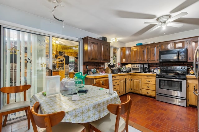 kitchen featuring ceiling fan, stainless steel electric range oven, and tasteful backsplash