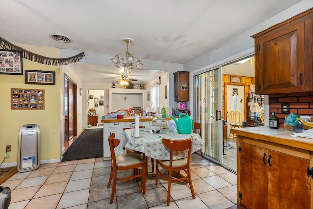 tiled dining room featuring a healthy amount of sunlight and ceiling fan