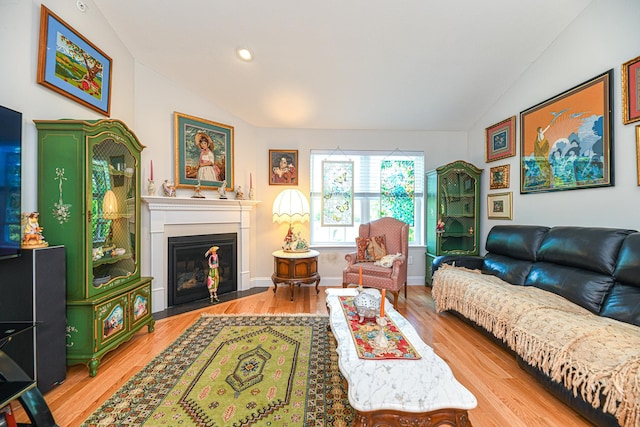 living room with light wood-type flooring and vaulted ceiling