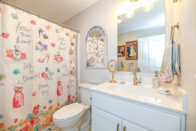 bathroom with a shower with shower curtain, vanity, and toilet