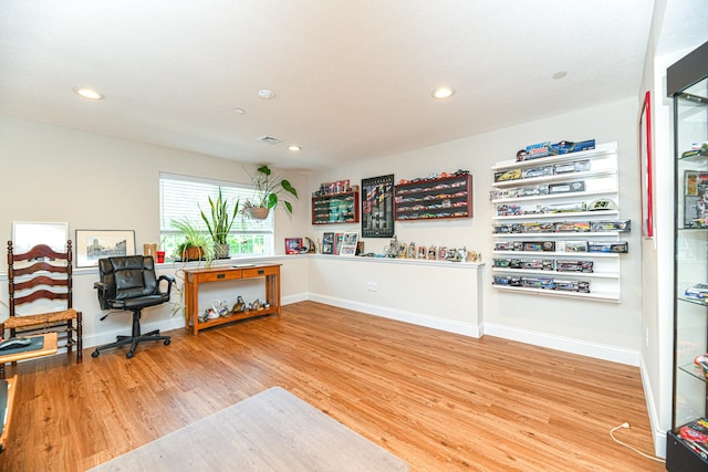 home office with hardwood / wood-style floors