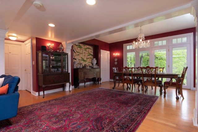 dining space featuring hardwood / wood-style flooring and a chandelier