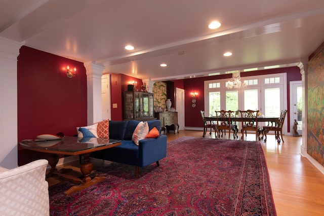 living room with a chandelier and light wood-type flooring