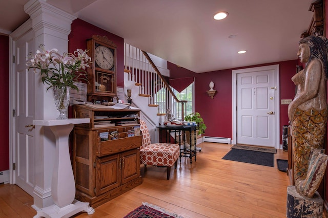 foyer with light hardwood / wood-style flooring and a baseboard radiator