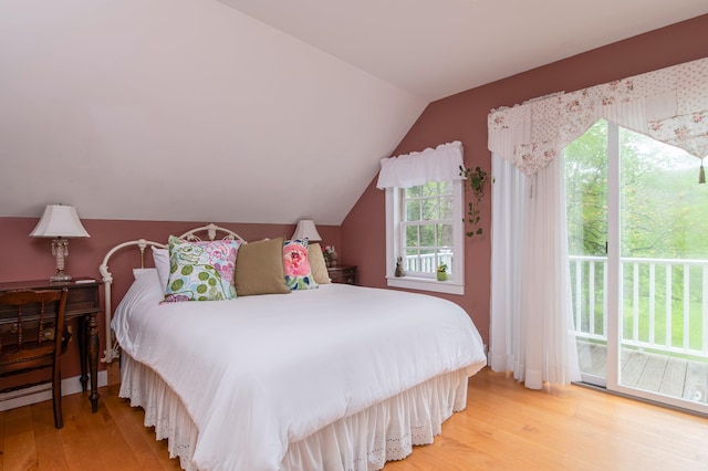 bedroom with hardwood / wood-style flooring, access to exterior, and lofted ceiling