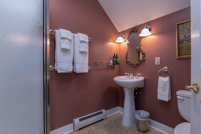 bathroom featuring toilet, vaulted ceiling, and a baseboard heating unit