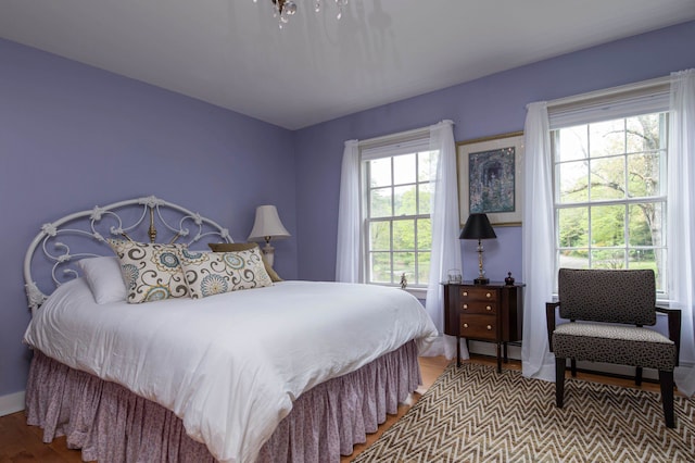 bedroom featuring multiple windows and light wood-type flooring