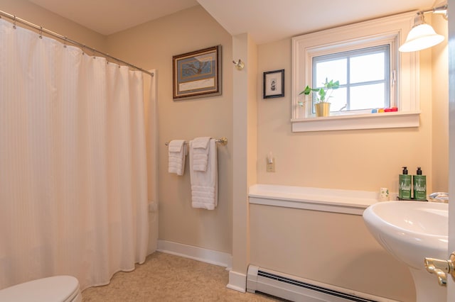 bathroom with sink, toilet, walk in shower, and a baseboard radiator