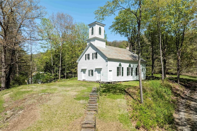 rear view of property featuring a yard