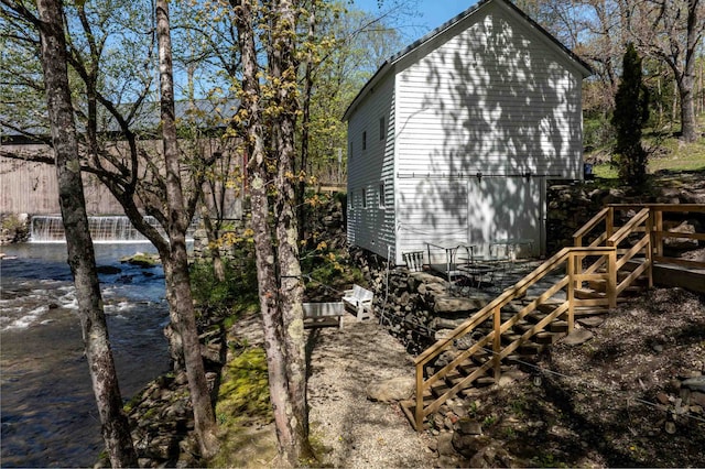 view of home's exterior with a water view